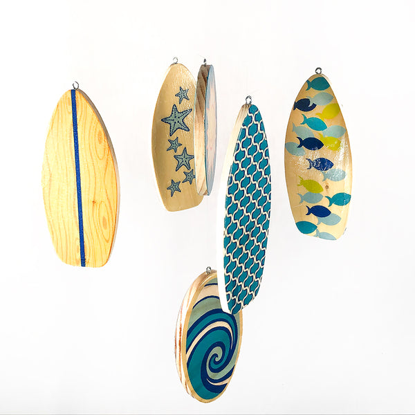 wooden surfboards on a baby crib mobile
