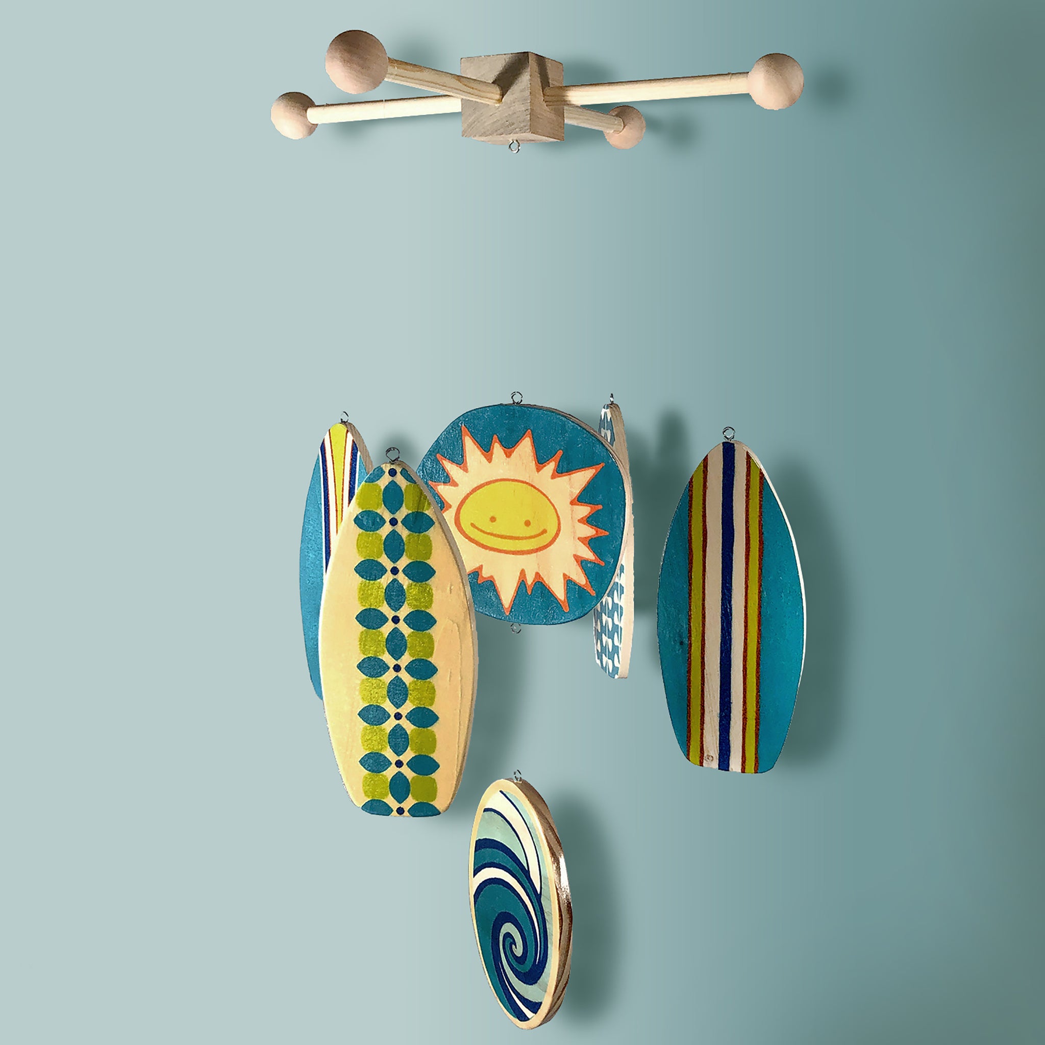 beach themed baby mobile with shades of blues and aquas for a surf inspired baby room