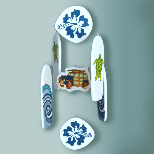 surfboards, a vintage woody car and tropical hibiscus flowers on this baby crib mobile